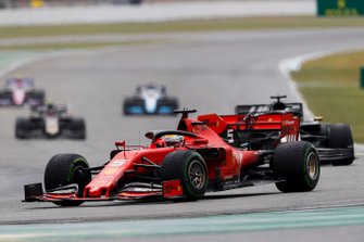 Sebastian Vettel, Ferrari SF90, leads Romain Grosjean, Haas F1 Team VF-19