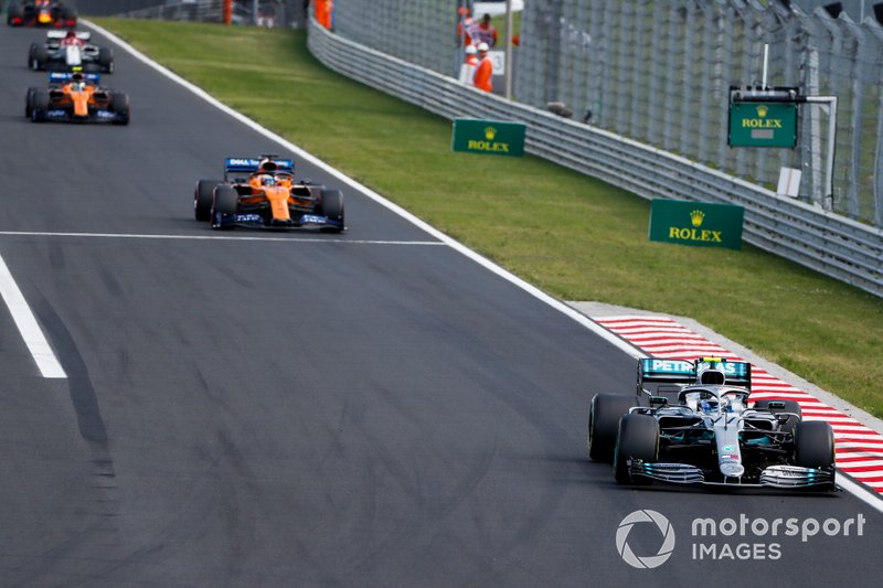 Valtteri Bottas, Mercedes AMG W10, leads Carlos Sainz Jr., McLaren MCL34, and Lando Norris, McLaren MCL34