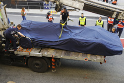 The Red Bull Racing RB13 TAG Heuer of Daniel Ricciardo is brought back to the garage under covers on the rear of a truck