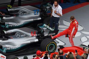 Sebastian Vettel, Ferrari, osserva la gomma posteriore Pirelli della monoposto di Lewis Hamilton, Mercedes-AMG F1 W09, nel parco chiuso