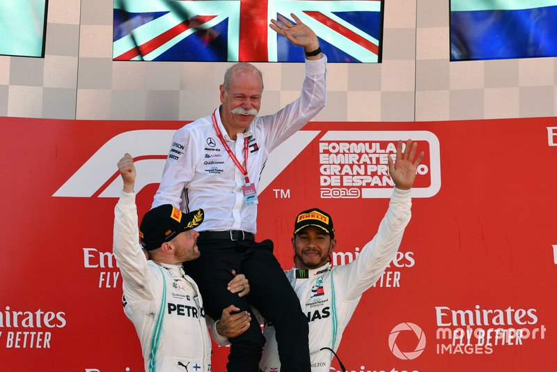 Valtteri Bottas, Mercedes AMG F1, 2nd position, and Lewis Hamilton, Mercedes AMG F1, 1st position, lift Dr Dieter Zetsche, CEO, Mercedes Benz, onto their shoulders on the podium