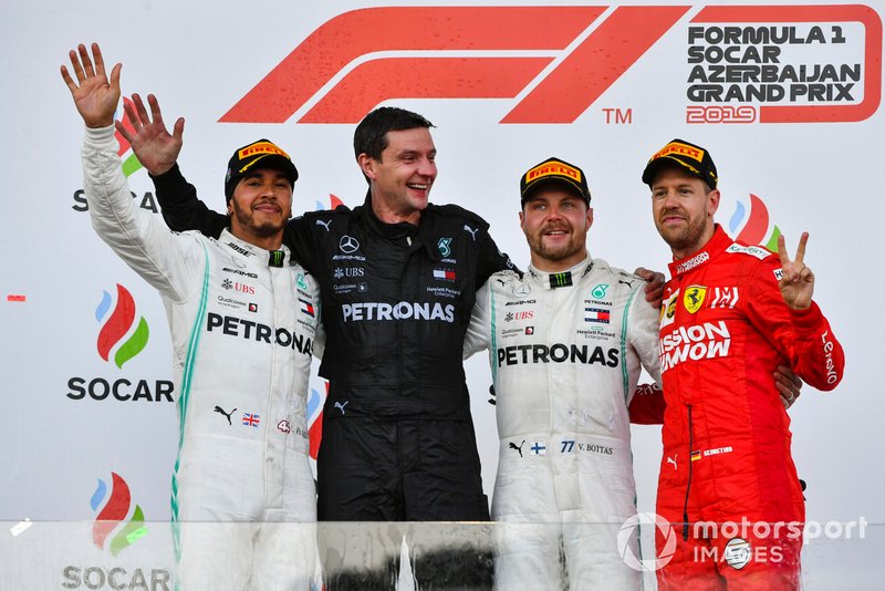 Lewis Hamilton, Mercedes AMG F1, the Mercedes Constructors trophy delegate, Valtteri Bottas, Mercedes AMG F1, 1st position, and Sebastian Vettel, Ferrari, 3rd position, on the podium