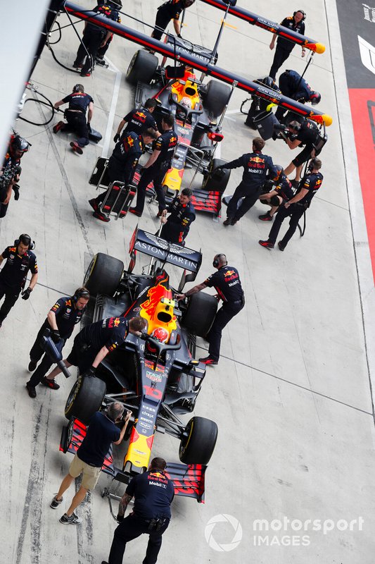 The Red Bull tea in the pit lane with the cars of Max Verstappen, Red Bull Racing RB15, and Pierre Gasly, Red Bull Racing RB15