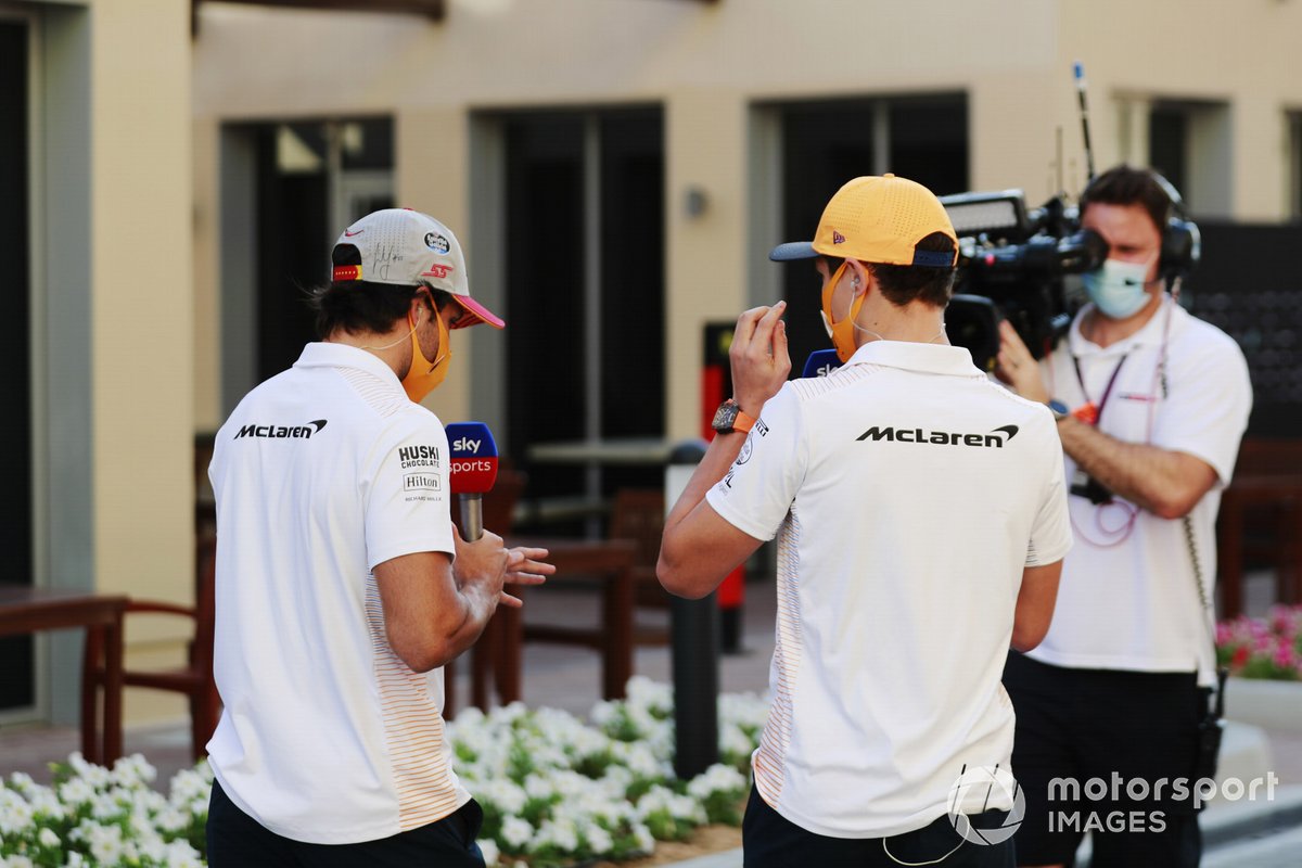 Lando Norris, McLaren and Carlos Sainz Jr., McLaren, are filmed in the paddock