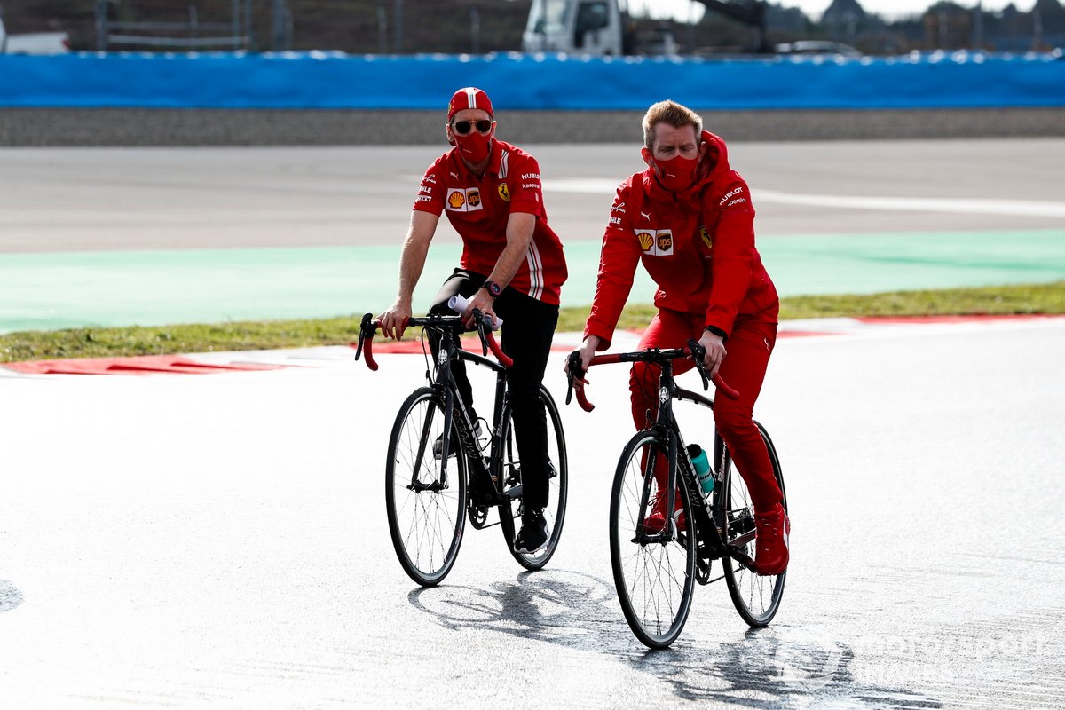Sebastian Vettel, Ferrari walks the track on a bike