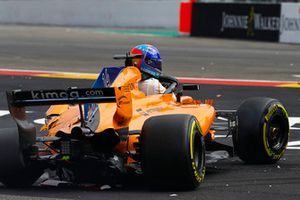 Fernando Alonso, McLaren MCL33, climbs from his heavily damaged car on the opening lap