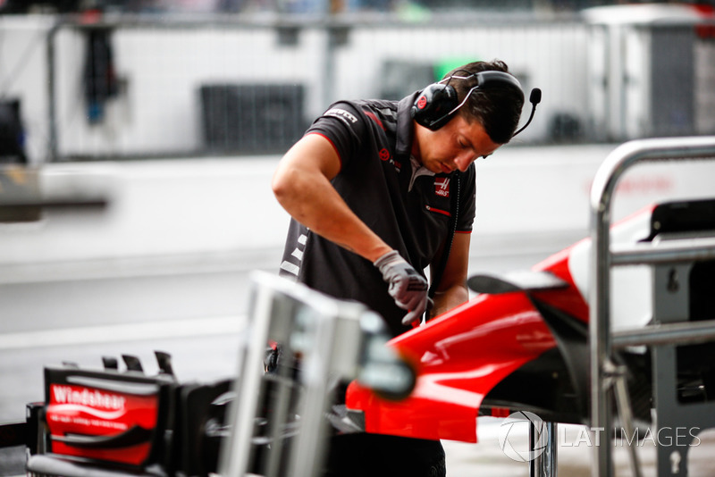 A Haas F1 engineer works on some bodywork