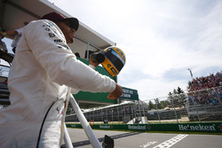 Lewis Hamilton, Mercedes AMG F1, shows off his Ayrton Senna helmet, a gift after equalling the Brazi