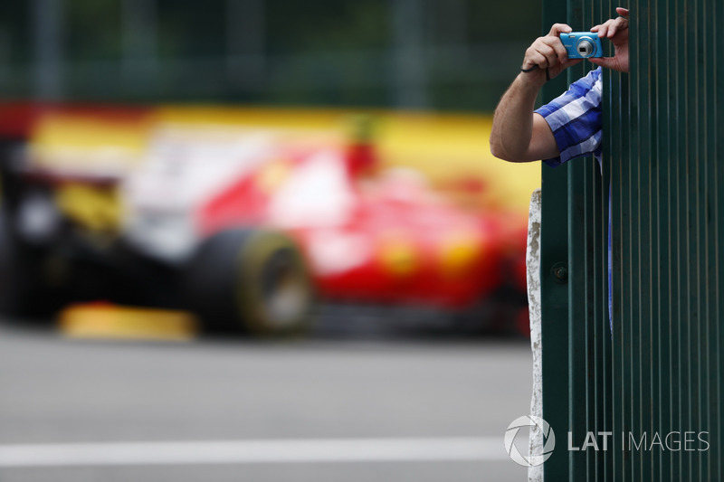 Kimi Raikkonen, Ferrari SF70H, passes a fan taking a picture