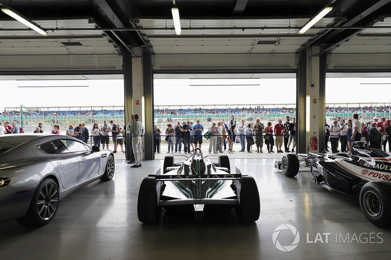 Fans view a garage filled with classic Williams F1 machinery