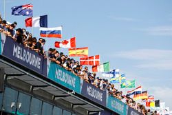 Fans watch from above the pit lane