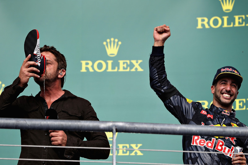 Actor Gerard Butler does a shoey on the podium with 3rd place Daniel Ricciardo, Red Bull Racing