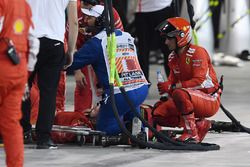 A Ferrari mechanic is tended by medics after being hit by the car of Kimi Raikkonen, Ferrari SF71H during a pit stop