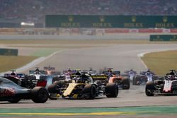 Kevin Magnussen, Haas F1 Team VF-18, leads Nico Hulkenberg, Renault Sport F1 Team R.S. 18, Romain Grosjean, Haas F1 Team VF-18, Sergio Perez, Force India VJM11, Fernando Alonso, McLaren MCL33, at the start of the race