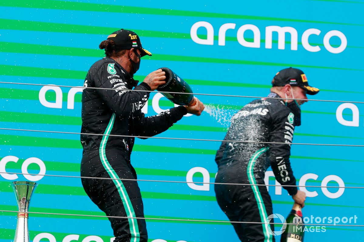 Lewis Hamilton, Mercedes-AMG Petronas F1, and Valtteri Bottas, Mercedes-AMG Petronas F1, spray champagne on the podium