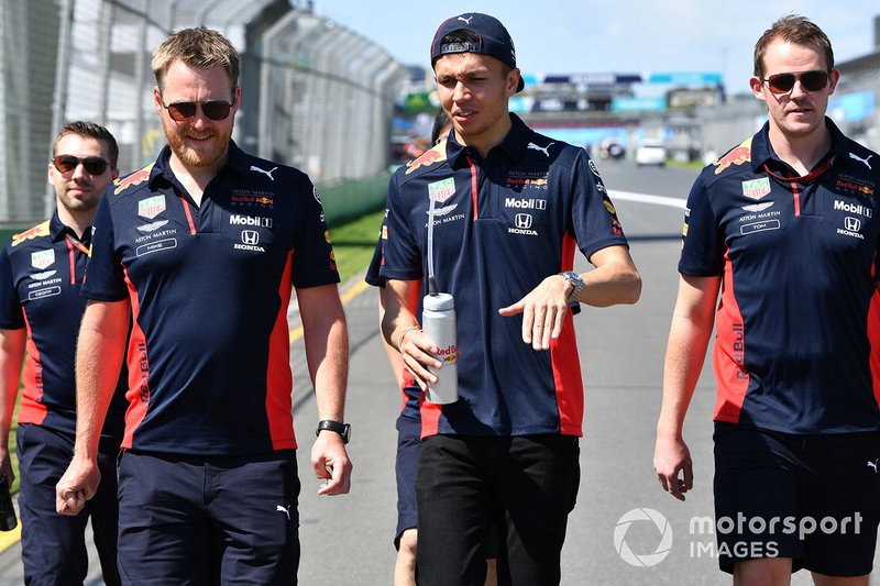 Alex Albon, Red Bull Racing walks the track with members of his team
