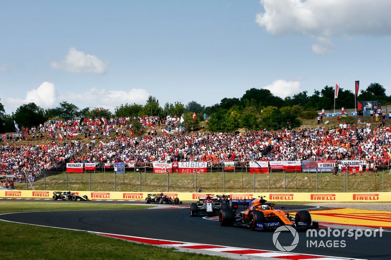Lando Norris, McLaren MCL34, leads Kimi Raikkonen, Alfa Romeo Racing C38, and Pierre Gasly, Red Bull Racing RB15