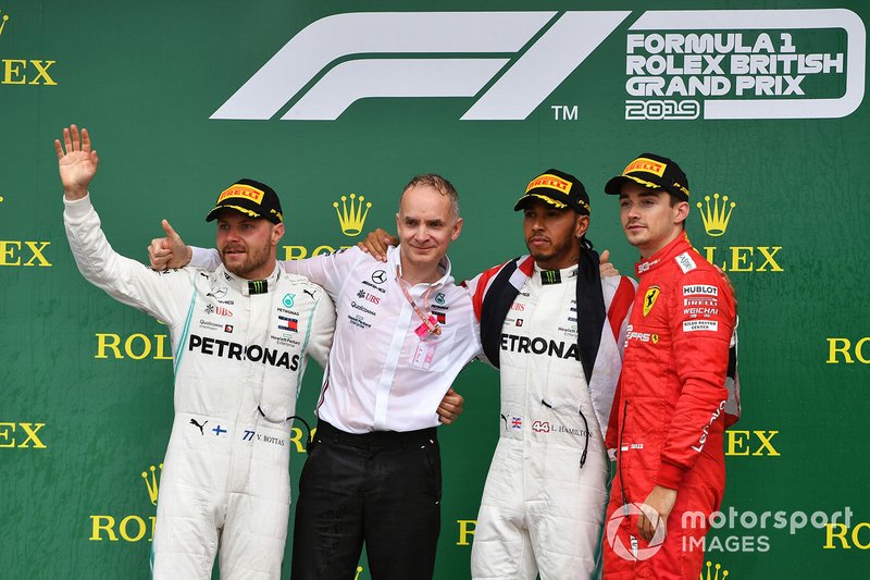 Valtteri Bottas, Mercedes AMG F1, 2nd position, the Mercedes Constructors trophy recipient, Lewis Hamilton, Mercedes AMG F1, 1st position, and Charles Leclerc, Ferrari, 3rd position, on the podium