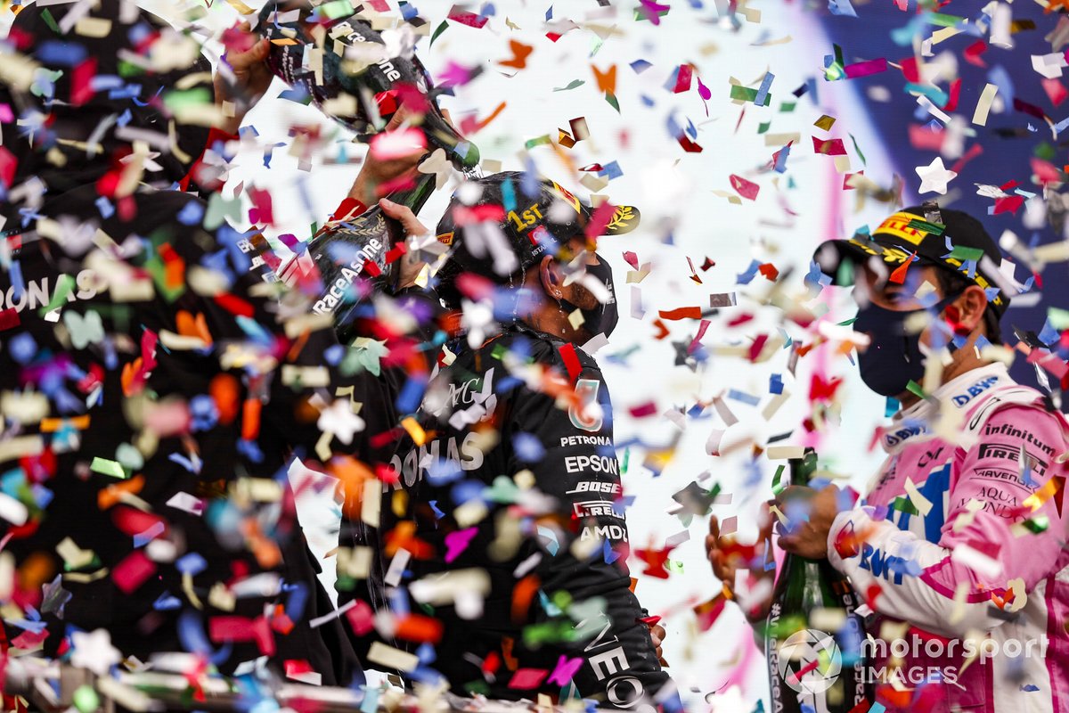 Lewis Hamilton, Mercedes-AMG F1, celebrates on the podium after winning the race, to take his 7th World Championship title, with Sergio Perez, Racing Point, 2nd position,