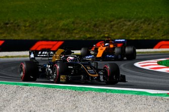 Romain Grosjean, Haas F1 Team VF-19, leads Carlos Sainz Jr., McLaren MCL34