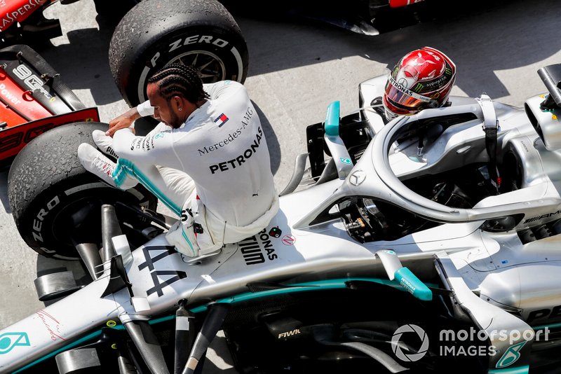 Lewis Hamilton, Mercedes AMG F1, 1st position, sits on his car in Parc Ferme