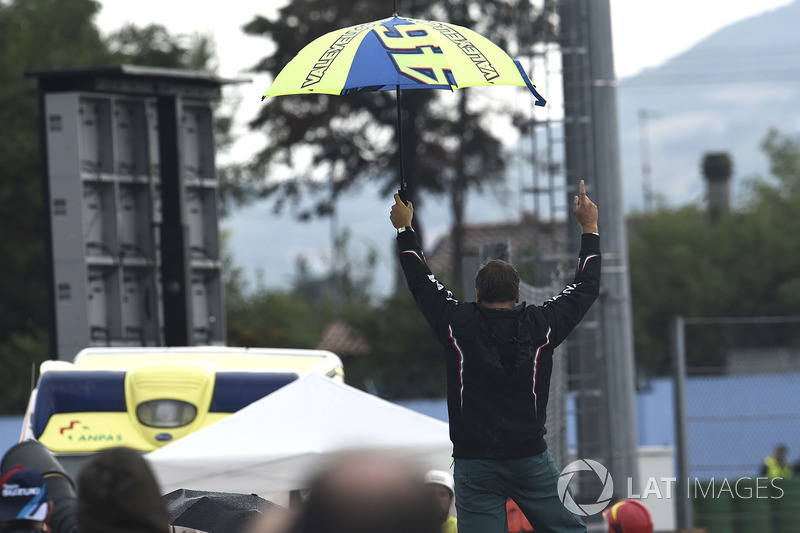 Rossi fan standing on the tyre wall celebrating Lorenzo's crash