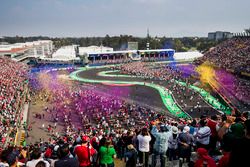 Fans watch the podium ceremony and invade the track