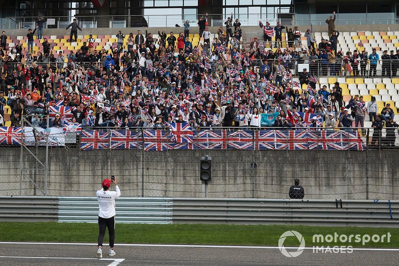 Race winner Lewis Hamilton, Mercedes AMG F1, takes a photo of his supporters