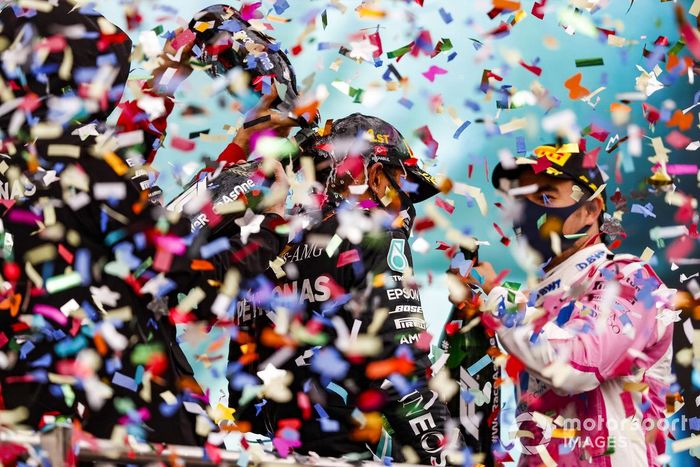 Lewis Hamilton, Mercedes-AMG F1, celebrates on the podium after winning the race, to take his 7th World Championship title, with Sergio Perez, Racing Point, 2nd position, 