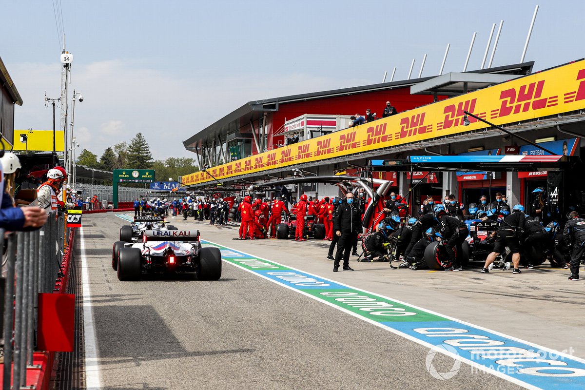 Mick Schumacher, Haas VF-21, passes Fernando Alonso, Alpine A521, in the pits