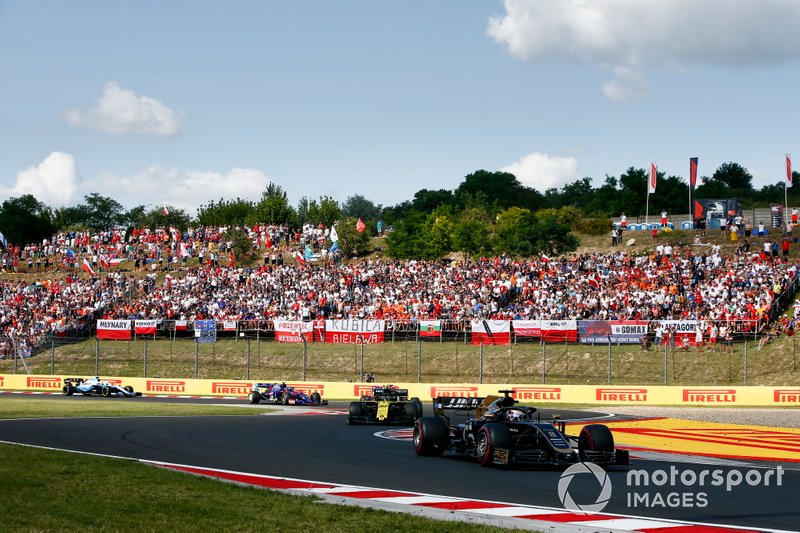 Romain Grosjean, Haas F1 Team VF-19, leads Nico Hulkenberg, Renault F1 Team R.S. 19