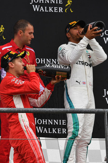 Sebastian Vettel, Ferrari and Lewis Hamilton, Mercedes AMG F1 celebrate on the podium with the champagne