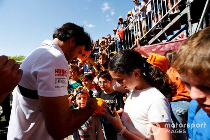 Carlos Sainz Jr., McLaren, signs autographs for fans