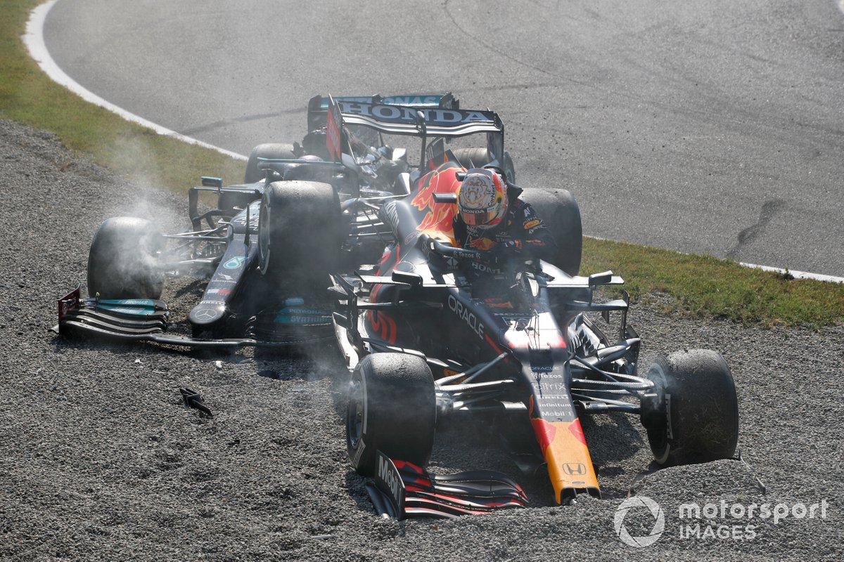 Max Verstappen, Red Bull Racing RB16B, and Lewis Hamilton, Mercedes W12, collide at the first chicane and retire from the race