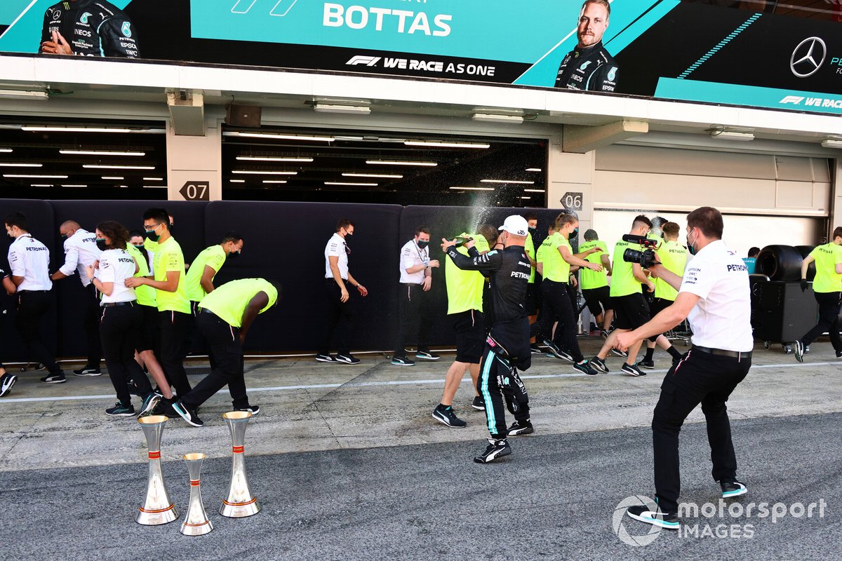 Valtteri Bottas, Mercedes, 3rd position, sprays a team mate with Champagne