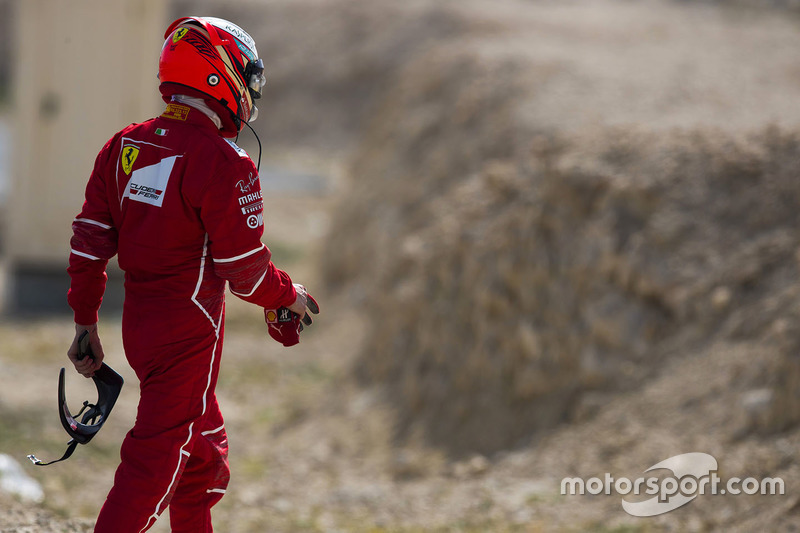 Kimi Raikkonen, Ferrari, walks back to his garage