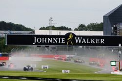 Half the field enter the pits as the Safety Car comes in