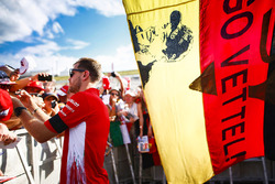 Sebastian Vettel, Ferrari, signs an autograph for a fan
