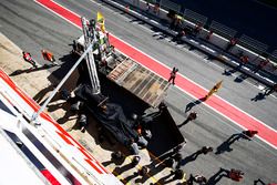 The McLaren MCL32 of Fernando Alonso is returned to the pits on a truck