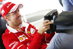 Sebastian Vettel, Ferrari, plays a computer game