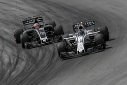 Lance Stroll, Williams FW40 and Kevin Magnussen, Haas F1 Team VF-17