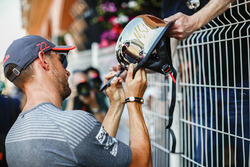 Jenson Button, McLaren, signs an autograph for a fan