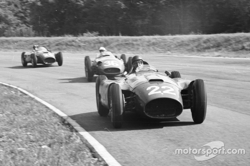 Juan Manuel Fangio, Lancia-Ferrari D50, leads Stirling Moss, Maserati 250F and Peter Collins, Lancia