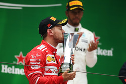 Sebastian Vettel, Ferrari kisses his trophy on the podium