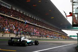 Lewis Hamilton, Mercedes AMG F1 W08, takes the chequered flag
