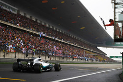 Lewis Hamilton, Mercedes AMG F1 W08, takes the chequered flag