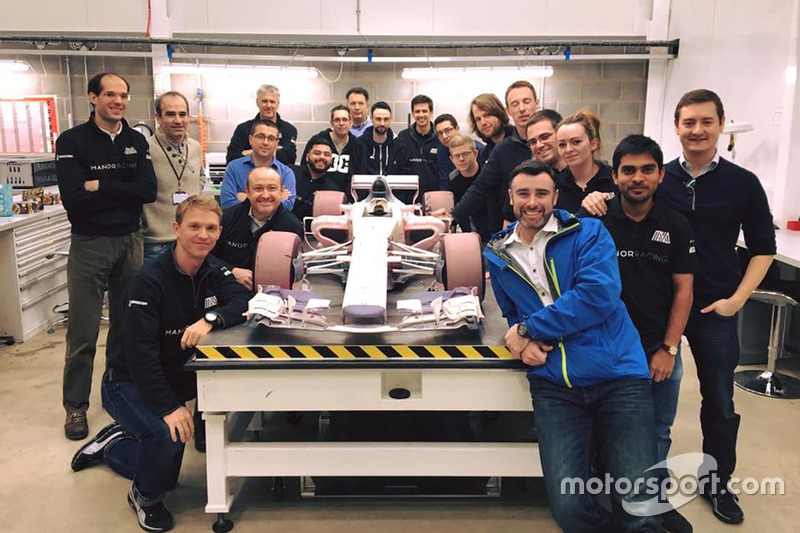 Manor wind tunnel model car with the team