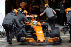 Fernando Alonso, McLaren MCL32, is returned to the garage