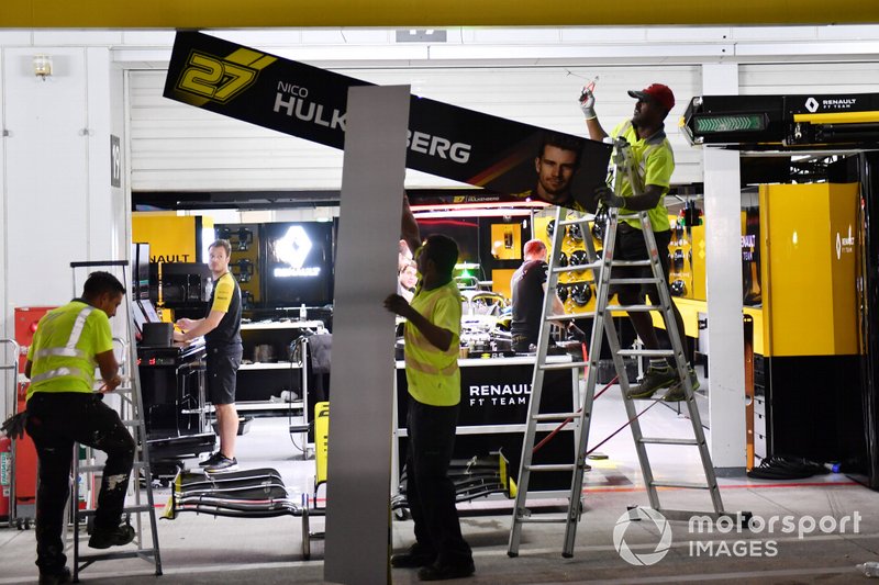 Teams clear equipment in the pit lane in anticipation of typhoon