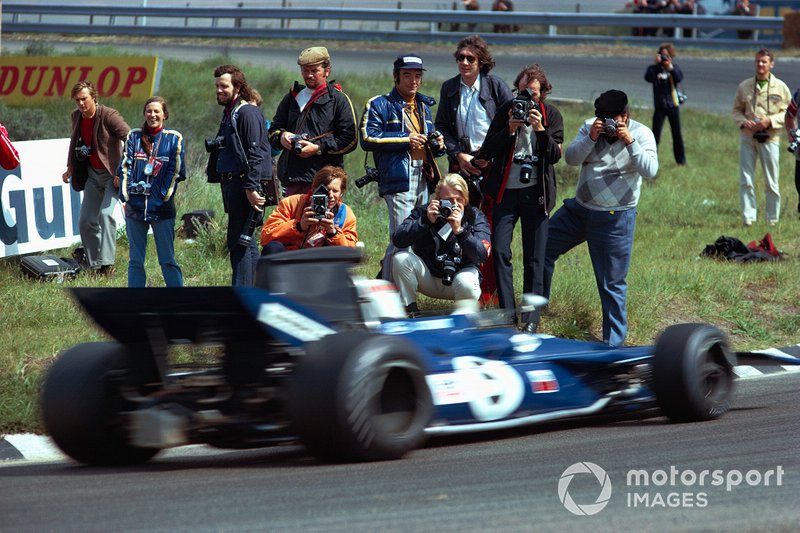 Photographers standing close to action of Jackie Stewart, Tyrrell 003 Ford